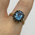 Blue Topaz & Sapphire Halo Cluster Ring 9ct 9k Yellow Gold - Size P 1/2